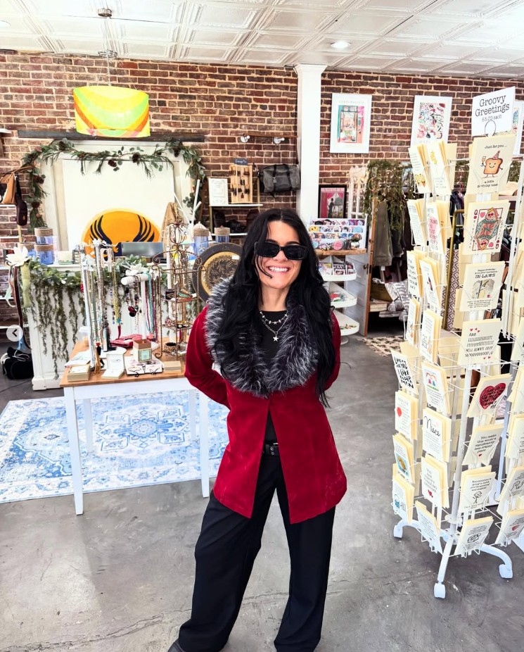 Happy shopper in a red faux-fur jacket inside Phoenix Rising